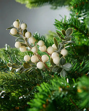 Decorative mistletoe branch with white berries on a green background