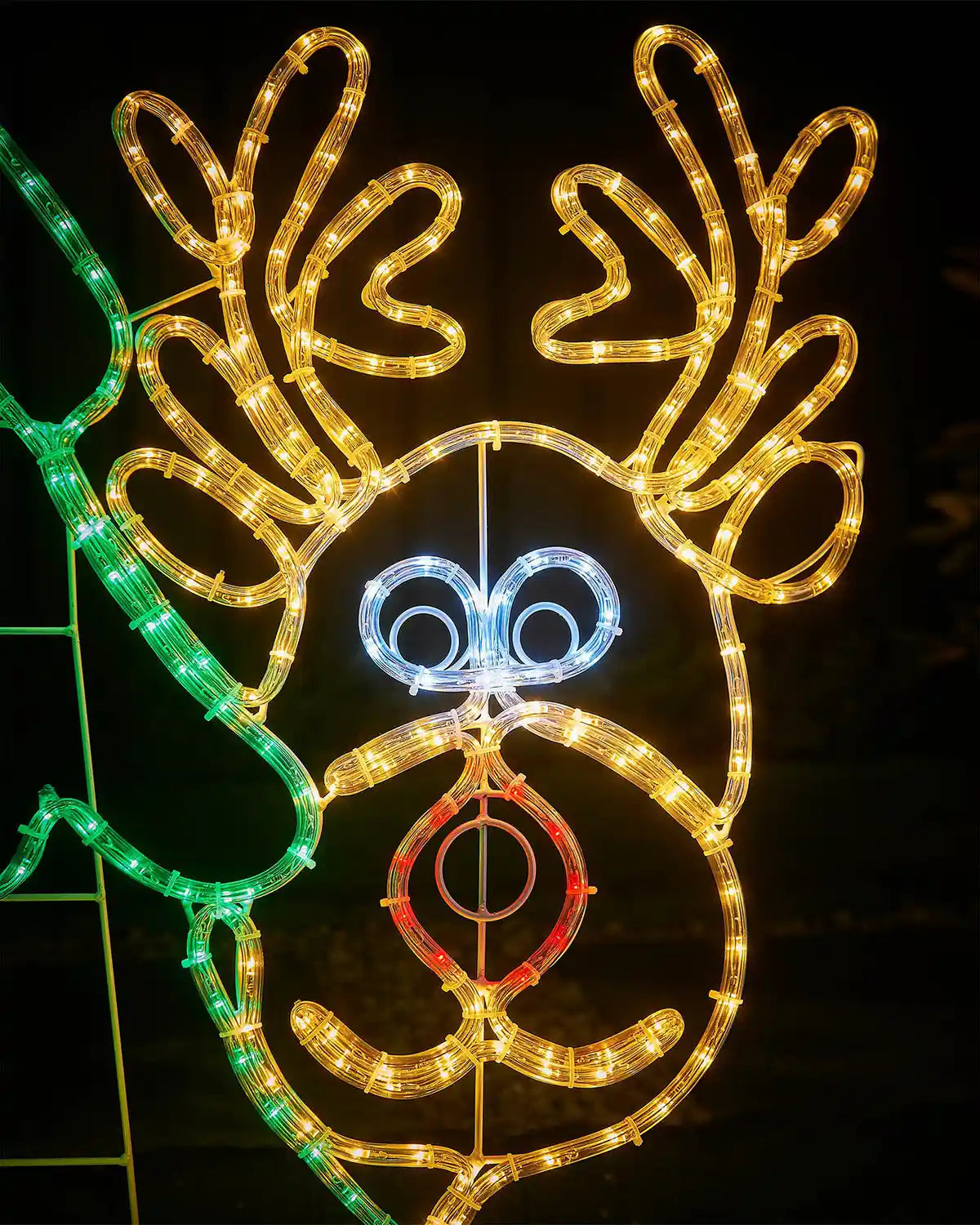 Decorative reindeer head light fixture with multicolored lights on a dark background