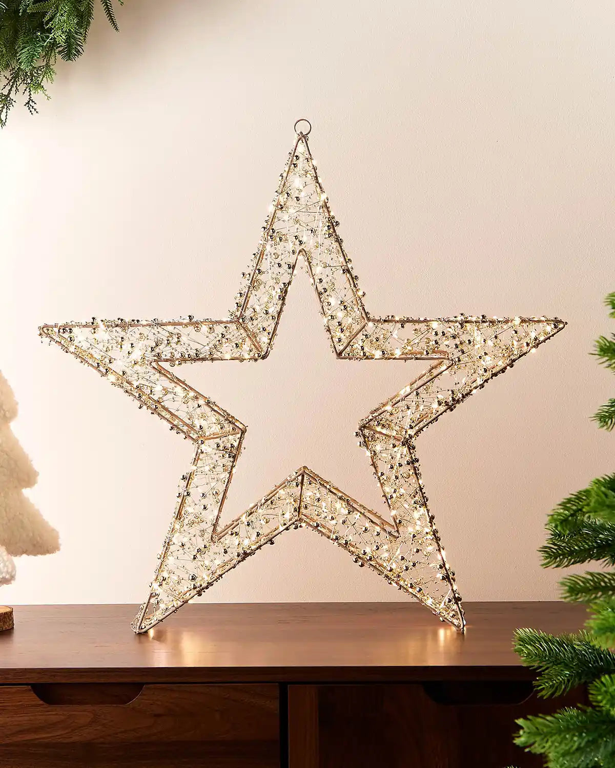 Decorative star with LED lights on a wooden surface with a neutral background