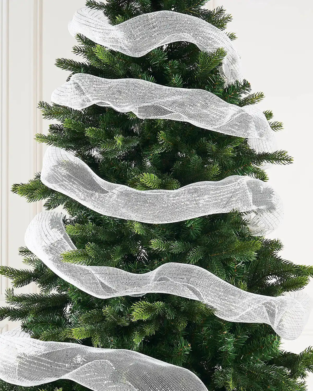 Decorative white and gold mesh ribbon on a Christmas tree