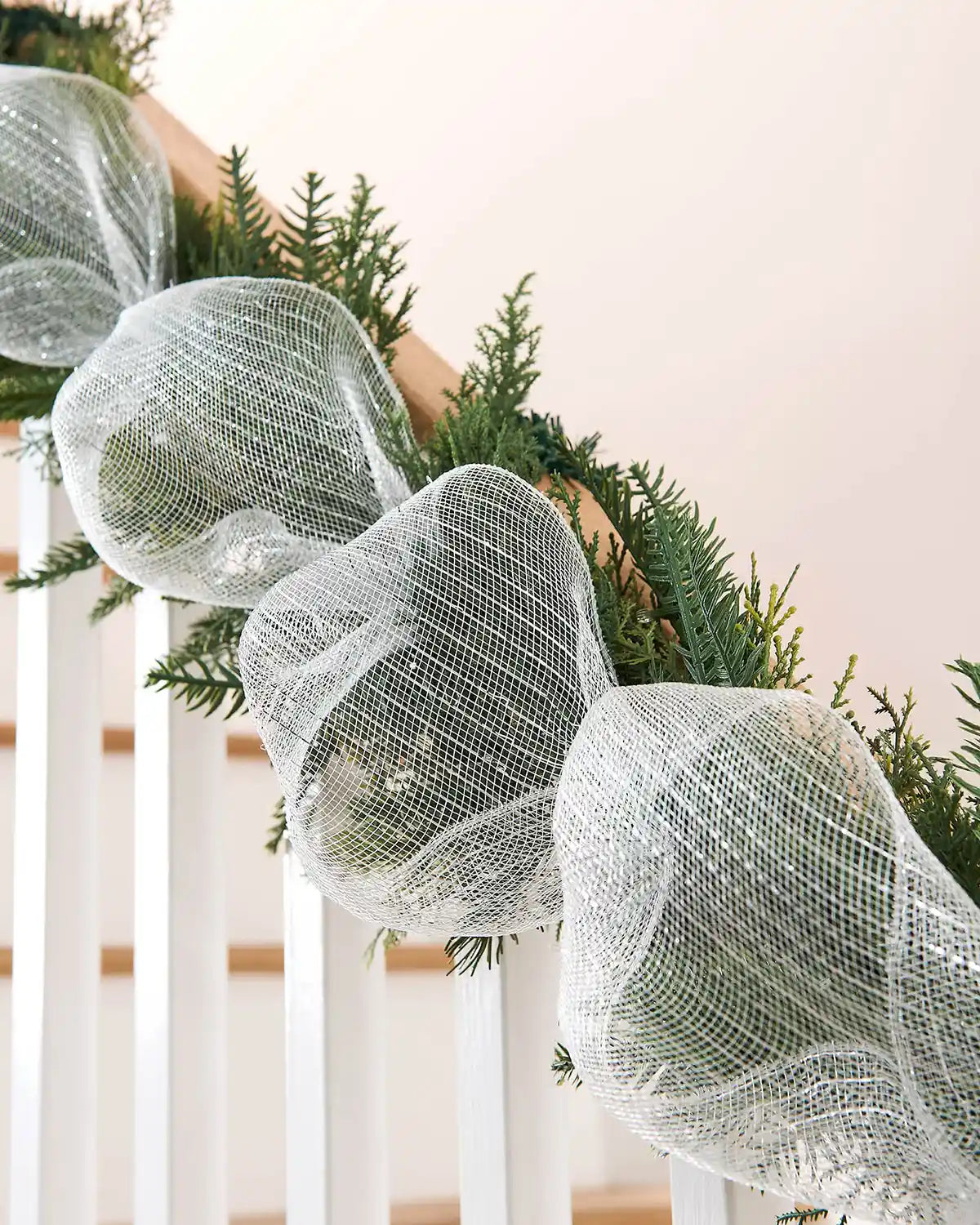 Decorative white mesh ribbon on a Christmas garland.