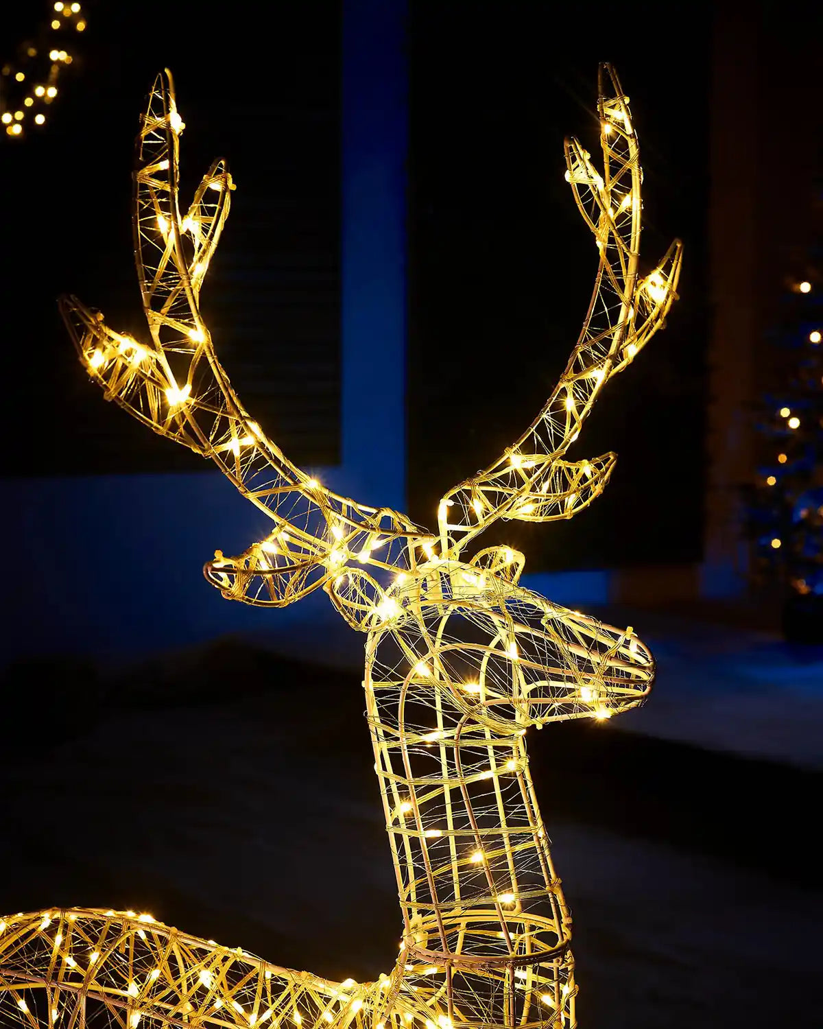 Decorative wire stag sculpture with LED lights against a dark background