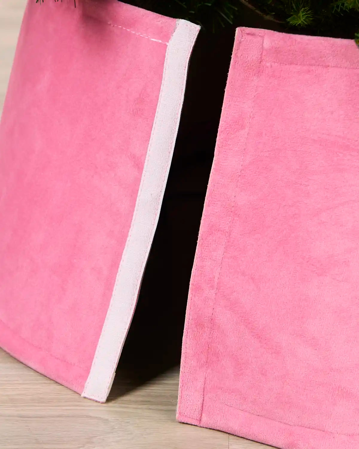 Detail of the Pink velvet tree skirt opened at the back, showing the Velcro closure used to secure it around the tree
