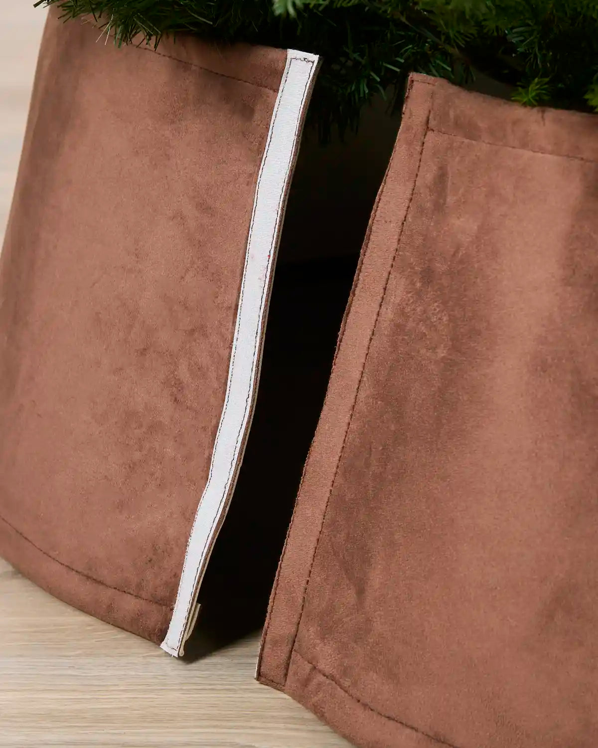 Detail of the espresso velvet tree skirt opened at the back, showing the Velcro closure used to secure it around the tree
