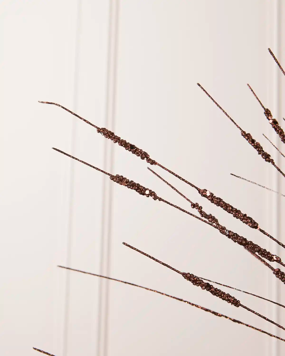 Detailed close-up of slender Espresso glitter stems with textured sections from the Glitter Wispy Spray