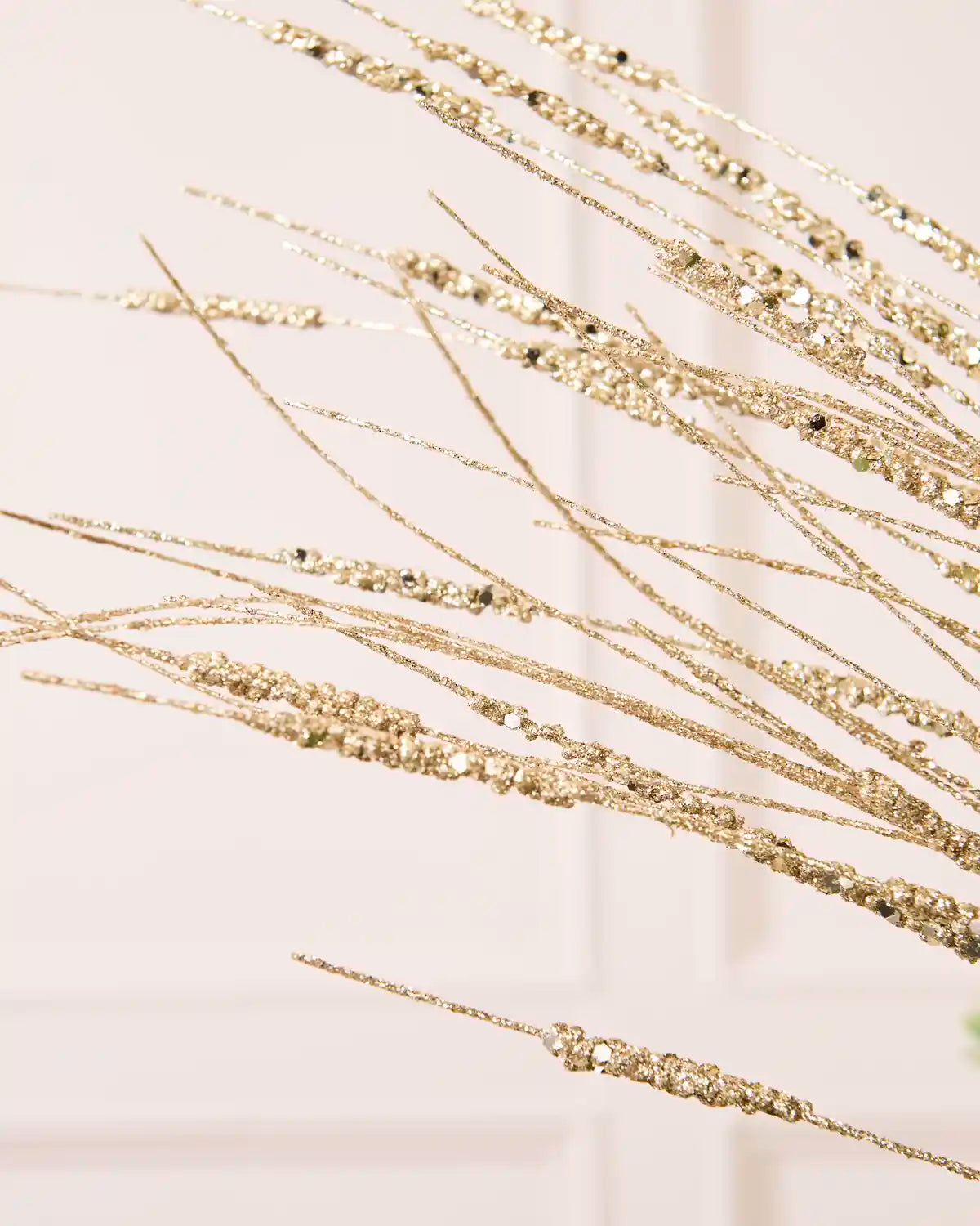 Detailed close-up of slender Latte glitter stems with textured sections from the Glitter Wispy Spray