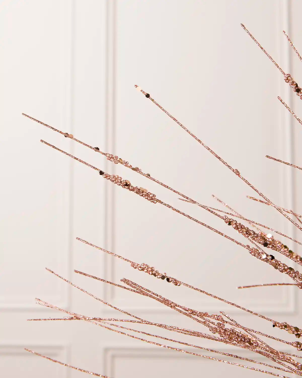 Detailed close-up of slender Rose Gold glitter stems with textured sections from the Glitter Wispy Spray