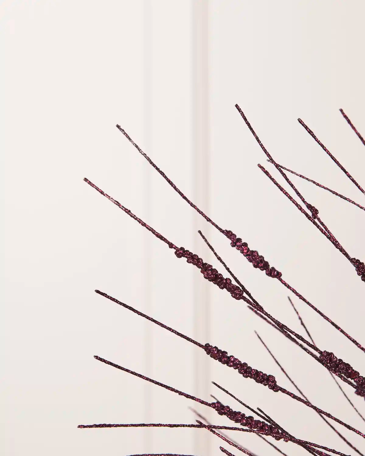Detailed close-up of slender purple glitter stems with textured sections from the Glitter Wispy Spray