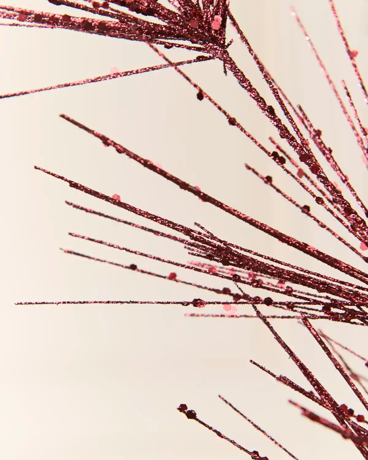 Detailed close-up of the Burgundy  Glitter Firework Spray, highlighting its fine glitter-covered stems and small decorative accents against a light background