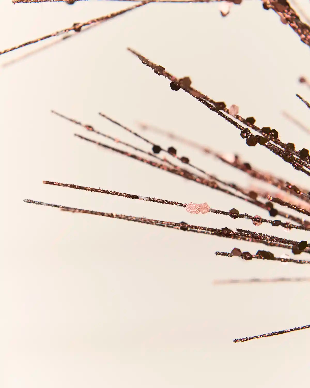 Detailed close-up of the  Espresso  Glitter Firework Spray, highlighting its fine glitter-covered stems and small decorative accents against a light background