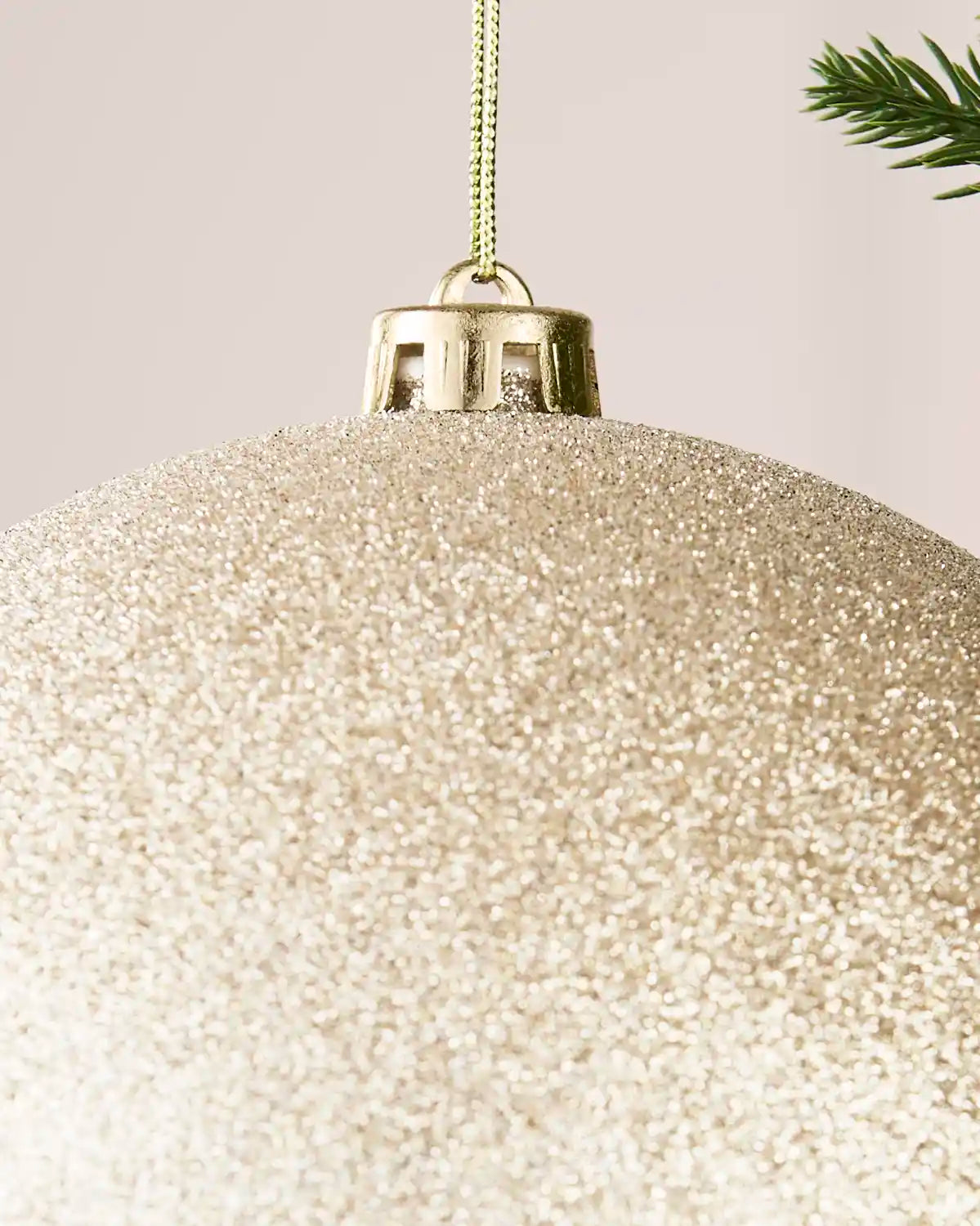 Detailed close-up of the Latte 20 cm glitter shatterproof bauble with its gold cap and matching hanging string.