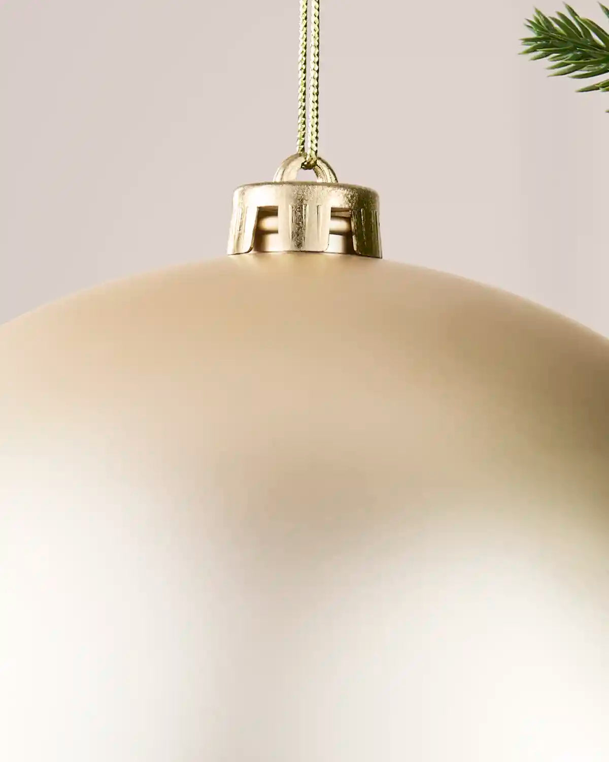Detailed close-up of the Latte 20 cm matt shatterproof bauble with its gold cap and matching hanging string.