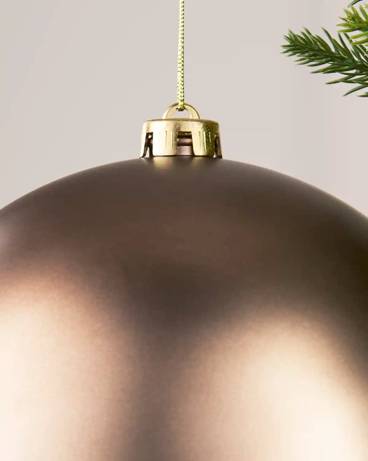 Detailed close-up of the Matt 20 cm Mocha shatterproof bauble with its gold cap and matching hanging string.