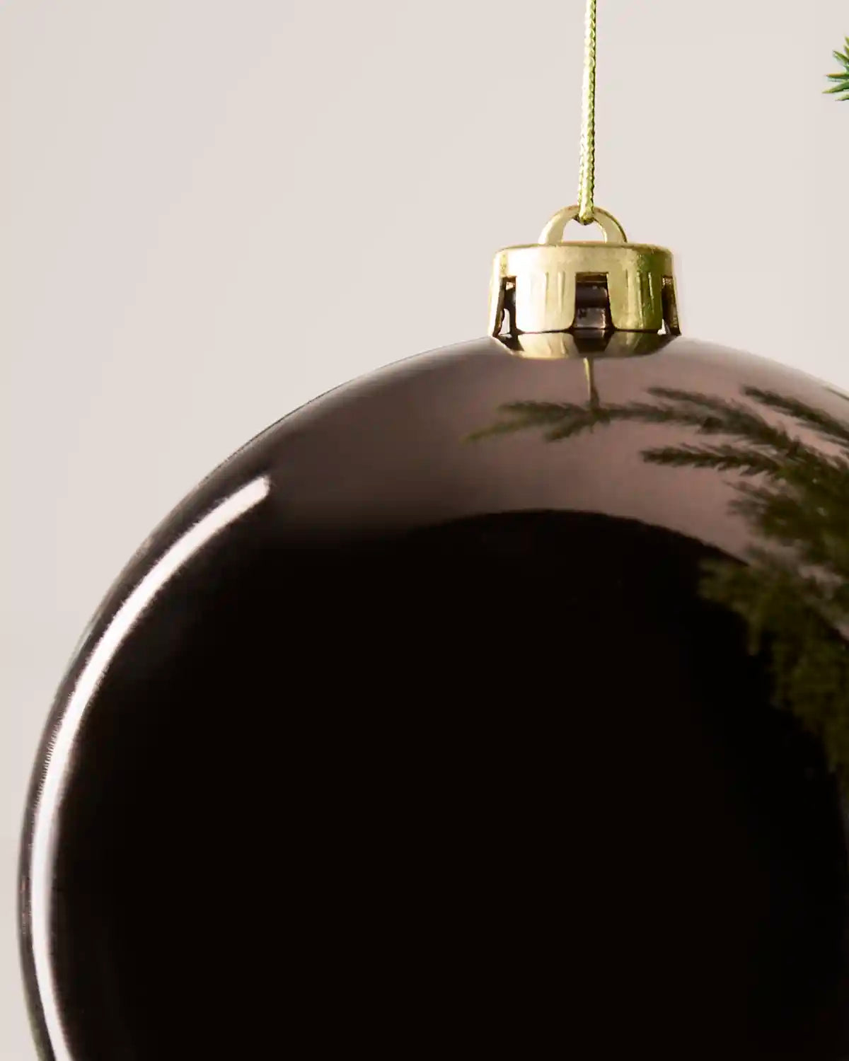 Detailed close-up of the Mocha 15 cm Shiny shatterproof bauble with its gold cap and matching hanging string.