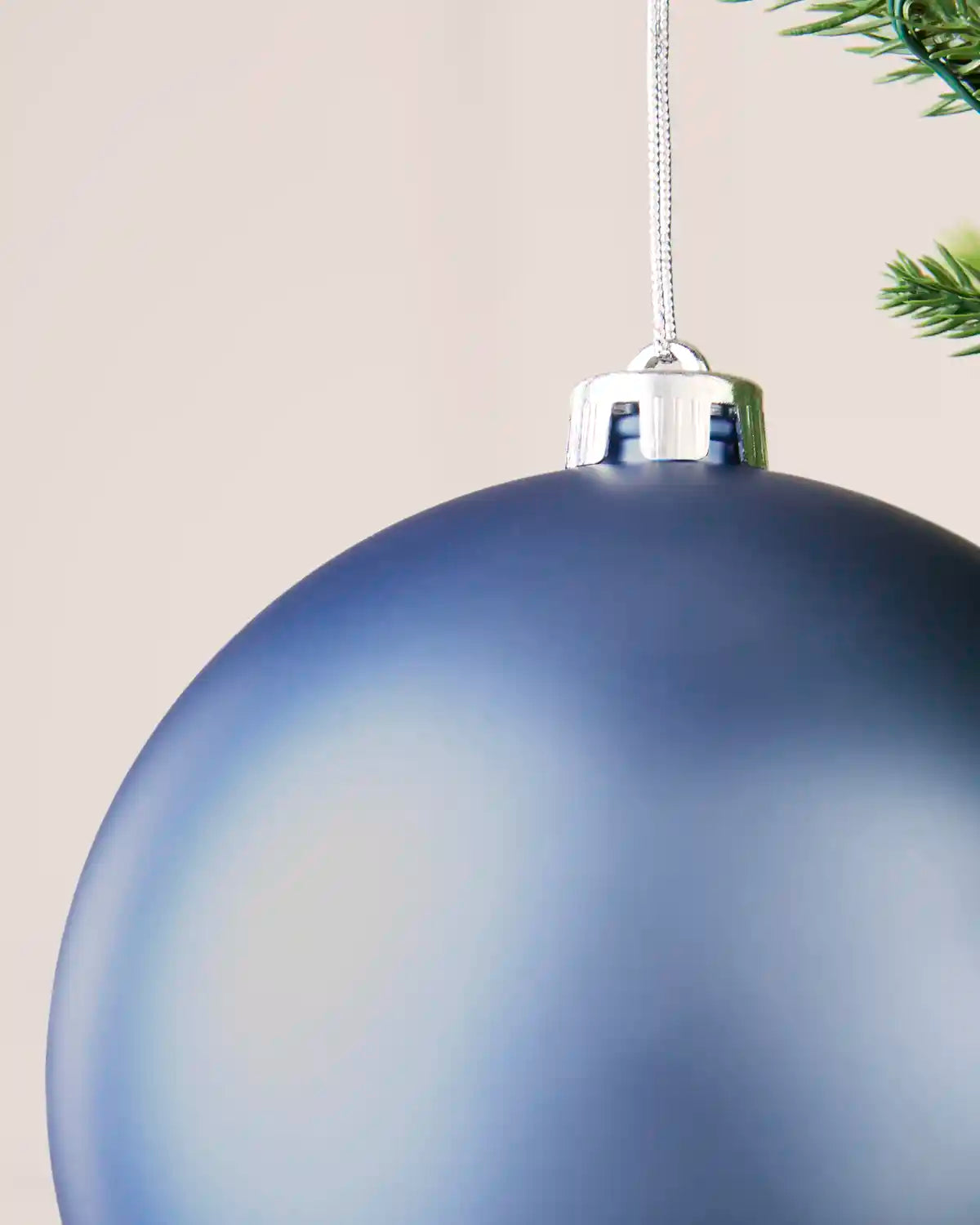 Detailed close-up of the ice blue 15 cm matt shatterproof bauble with its silver cap and matching hanging string.