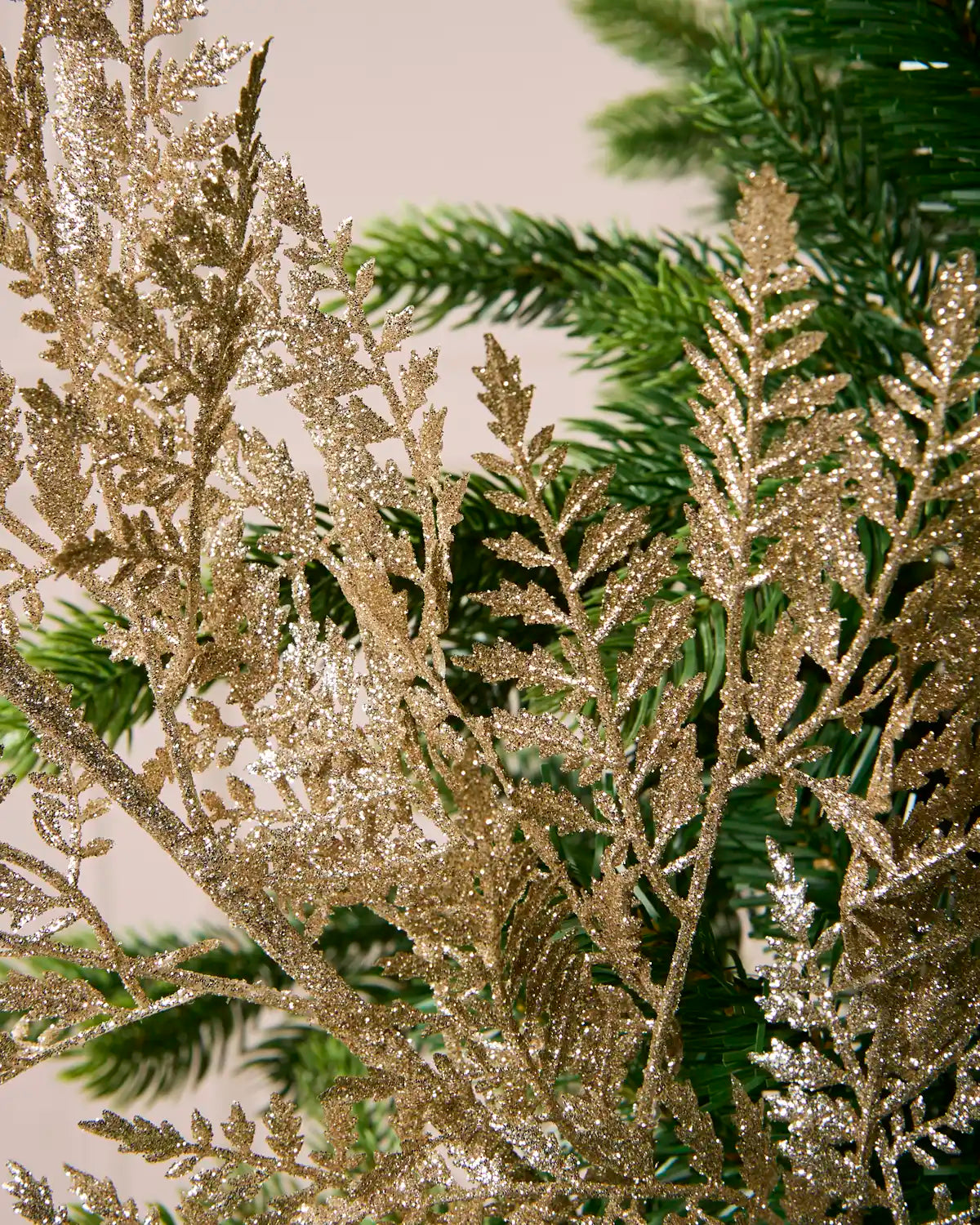 Detailed view of densely clustered gold glitter leaves and branches