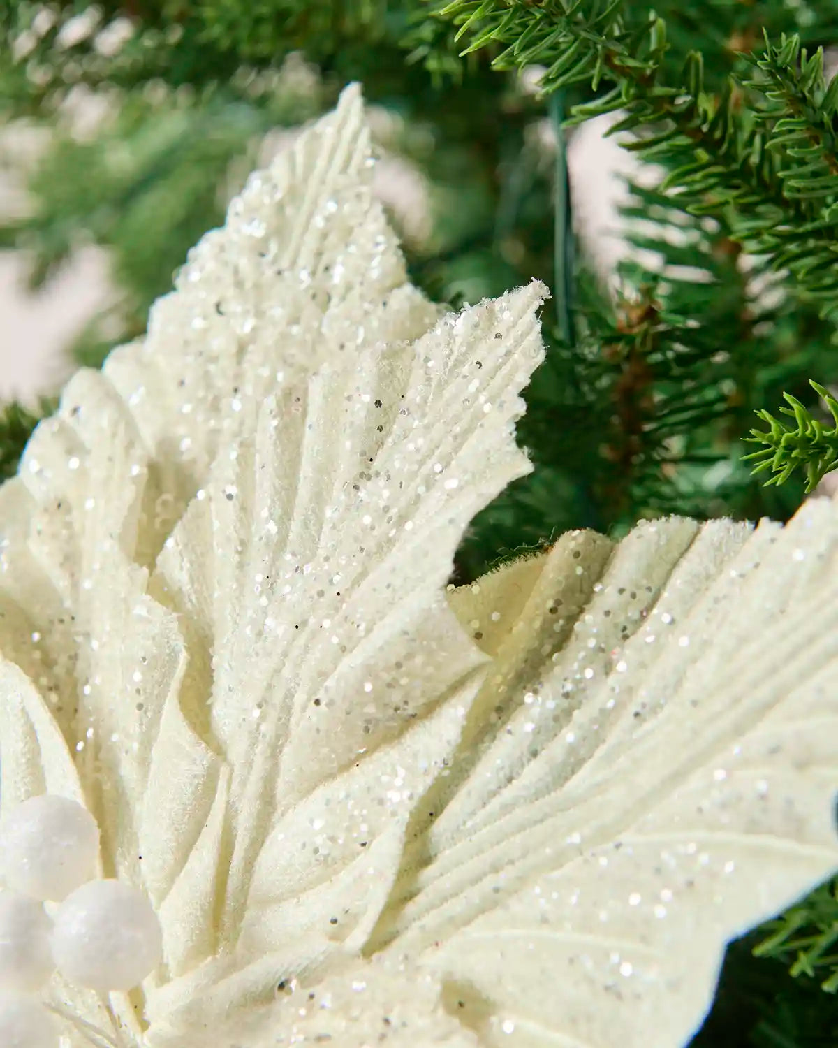 Detailed view of the glitter-covered cream poinsettia petals