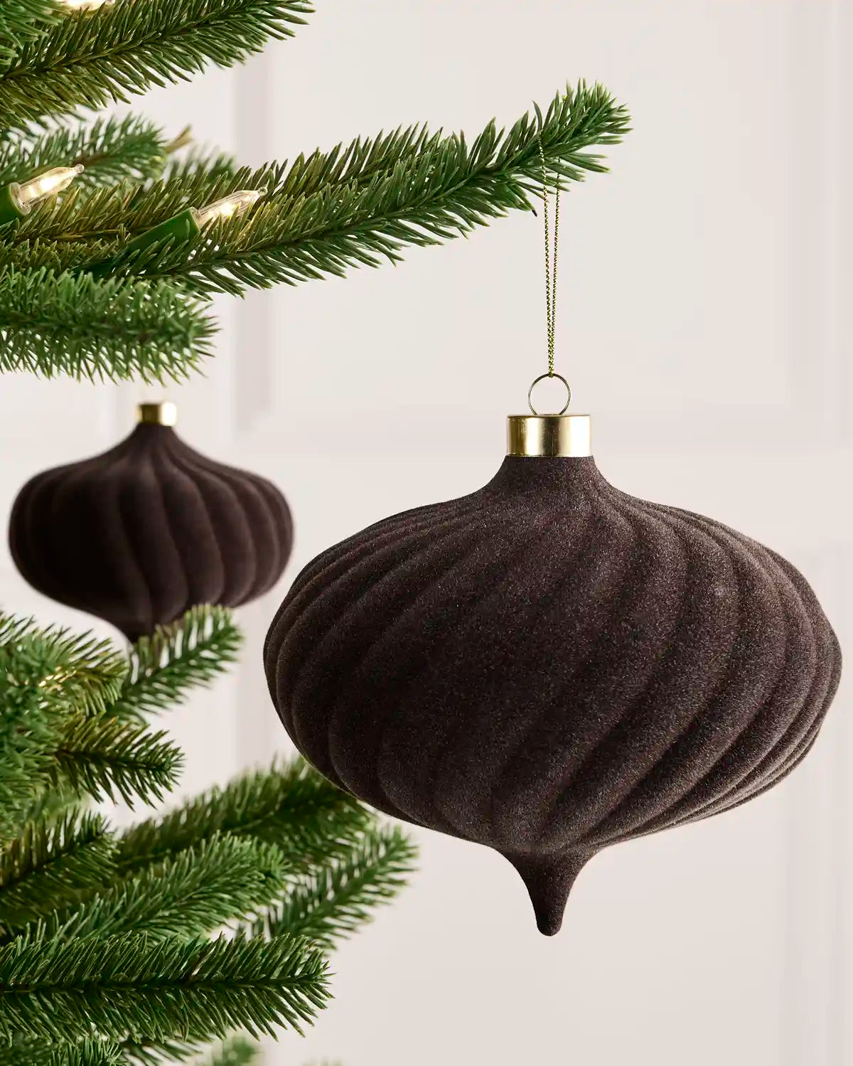 Espresso 15 cm oversized velvet Spiral bauble displayed on a Christmas tree with coordinating ornaments.
