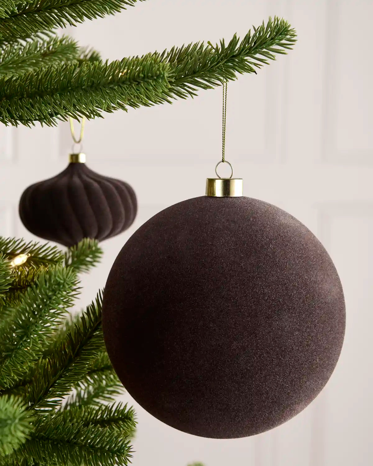 Espresso 15 cm oversized velvet Traditional bauble displayed on a Christmas tree with coordinating ornaments.
