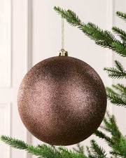 Espresso 20 cm oversized Glitter shatterproof bauble hanging on a Christmas tree with a gold cap and matching string.
