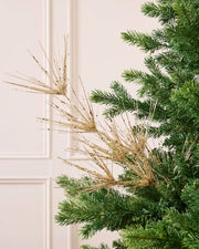Glitter Firework Spray in Latte, featuring multiple thin, glitter-covered branches in a firework shape against a green Christmas tree.
