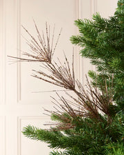 Glitter Firework Spray in Mocha, featuring multiple thin, glitter-covered branches in a firework shape against a green Christmas tree.
