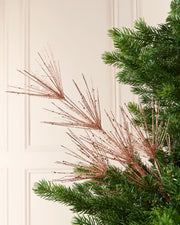 Glitter Firework Spray in  Rose Gold , featuring multiple thin, glitter-covered branches in a firework shape against a green Christmas tree.
