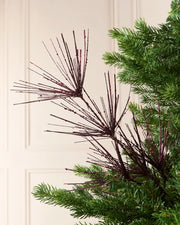 Glitter Firework Spray in purple, featuring multiple thin, glitter-covered branches in a firework shape against a green Christmas tree.