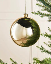 Gloss gold 15m oversized bauble on a Christmas tree branch 