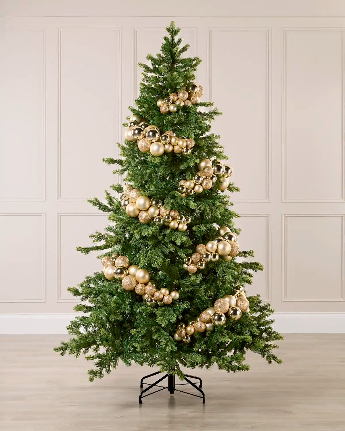Gold Bauble Cluster Arch decorating a Christmas tree, with glossy, matte, and glitter gold baubles