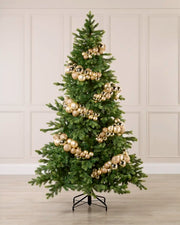 Gold Bauble Cluster Arch decorating a Christmas tree, with glossy, matte, and glitter gold baubles