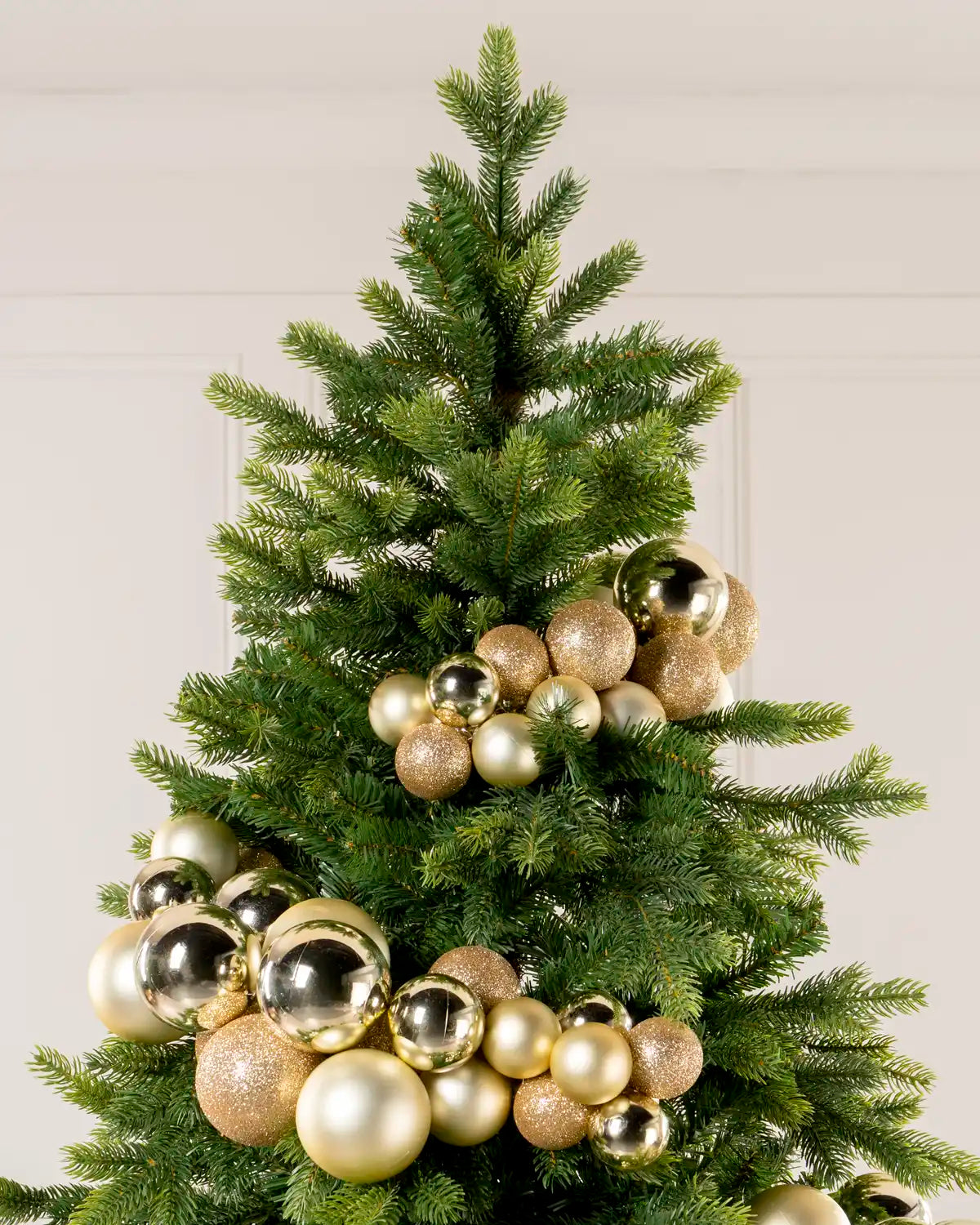 Gold Bauble Cluster Arch wrapped around a Christmas tree, showing clusters of gold baubles in different sizes and finishes