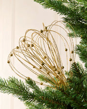 Gold Glitter Nest Christmas Tree Pick placed in green Christmas tree branches with a cream background
