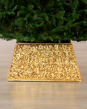 Gold Square sequin Christmas tree collar under a Christmas tree on a wooden floor 