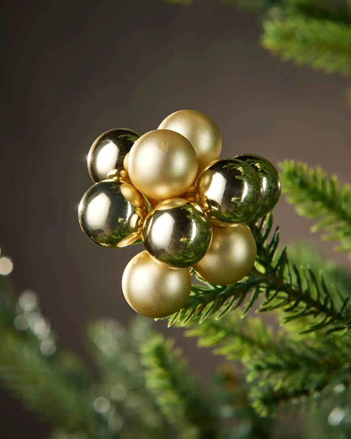 Gold decorative ornament on a branch with a blurred background