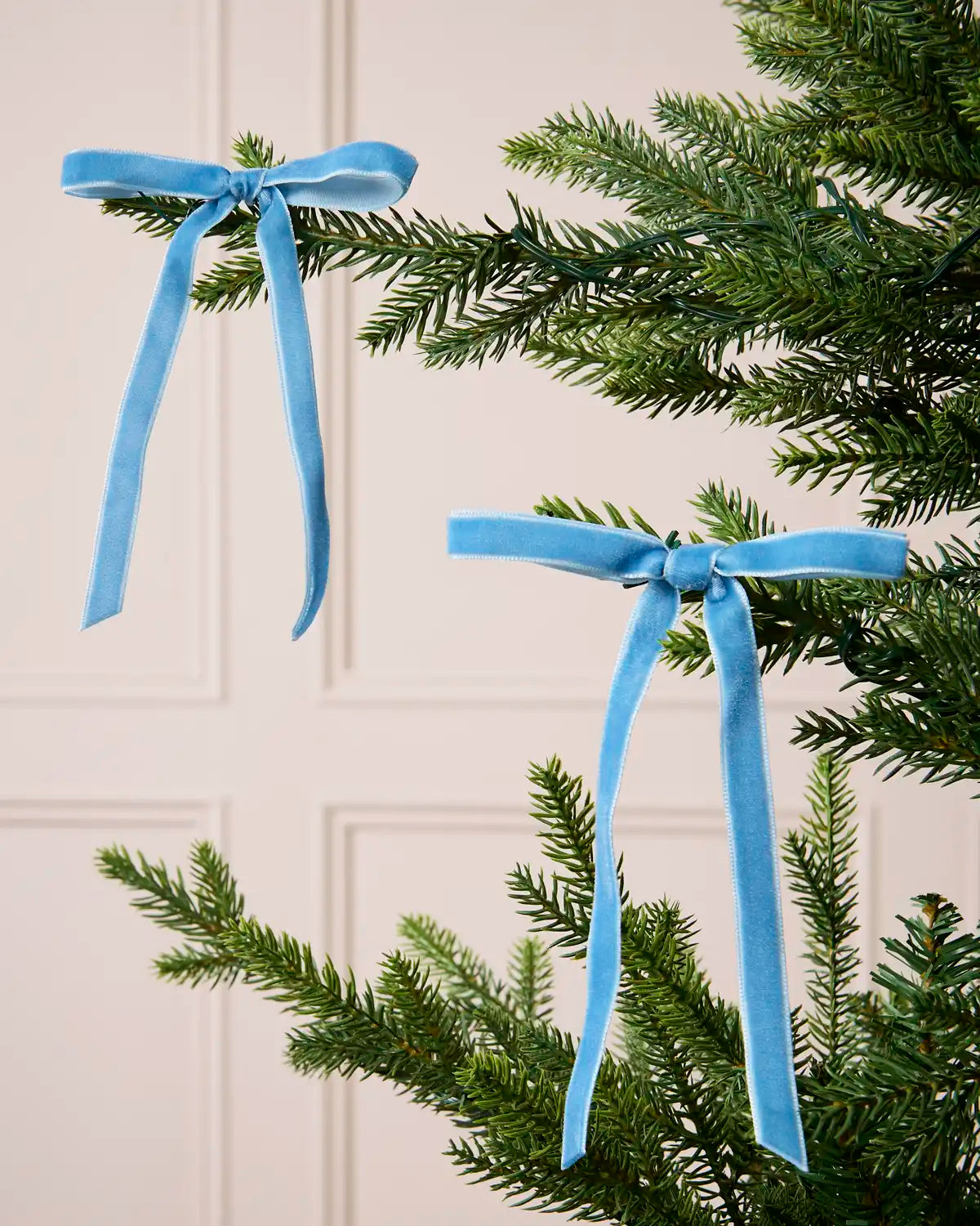 Ice Blue Velvet Bows displayed on a Christmas tree