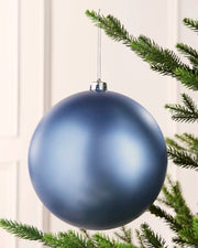 Ice blue 20 cm oversized matt shatterproof bauble hanging on a Christmas tree with a silver cap and matching string.
