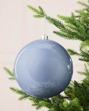Ice blue 20 cm oversized shiny shatterproof bauble hanging on a Christmas tree with a silver cap and matching string.

