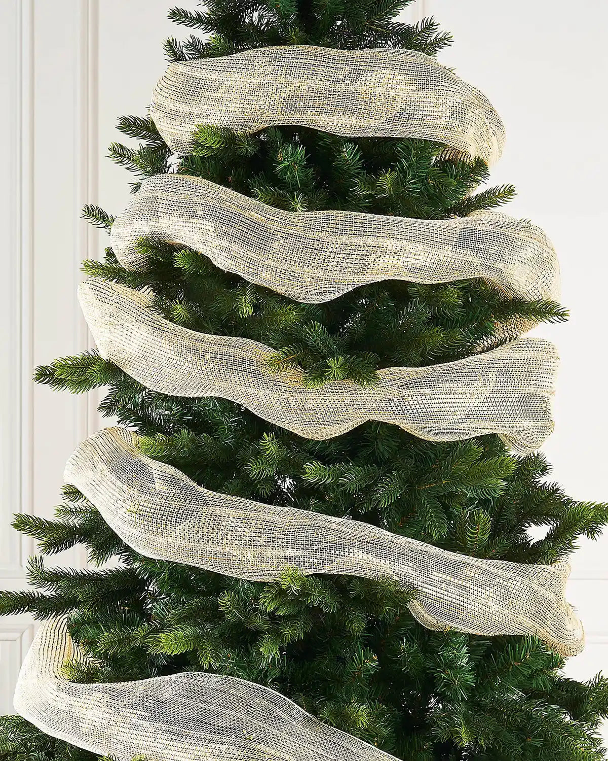 Ivory and Gold foil mesh ribbon wrapped around a Christmas tree against a cream panel background