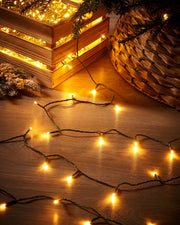 String lights on a wooden surface with a woven basket and decorative items.