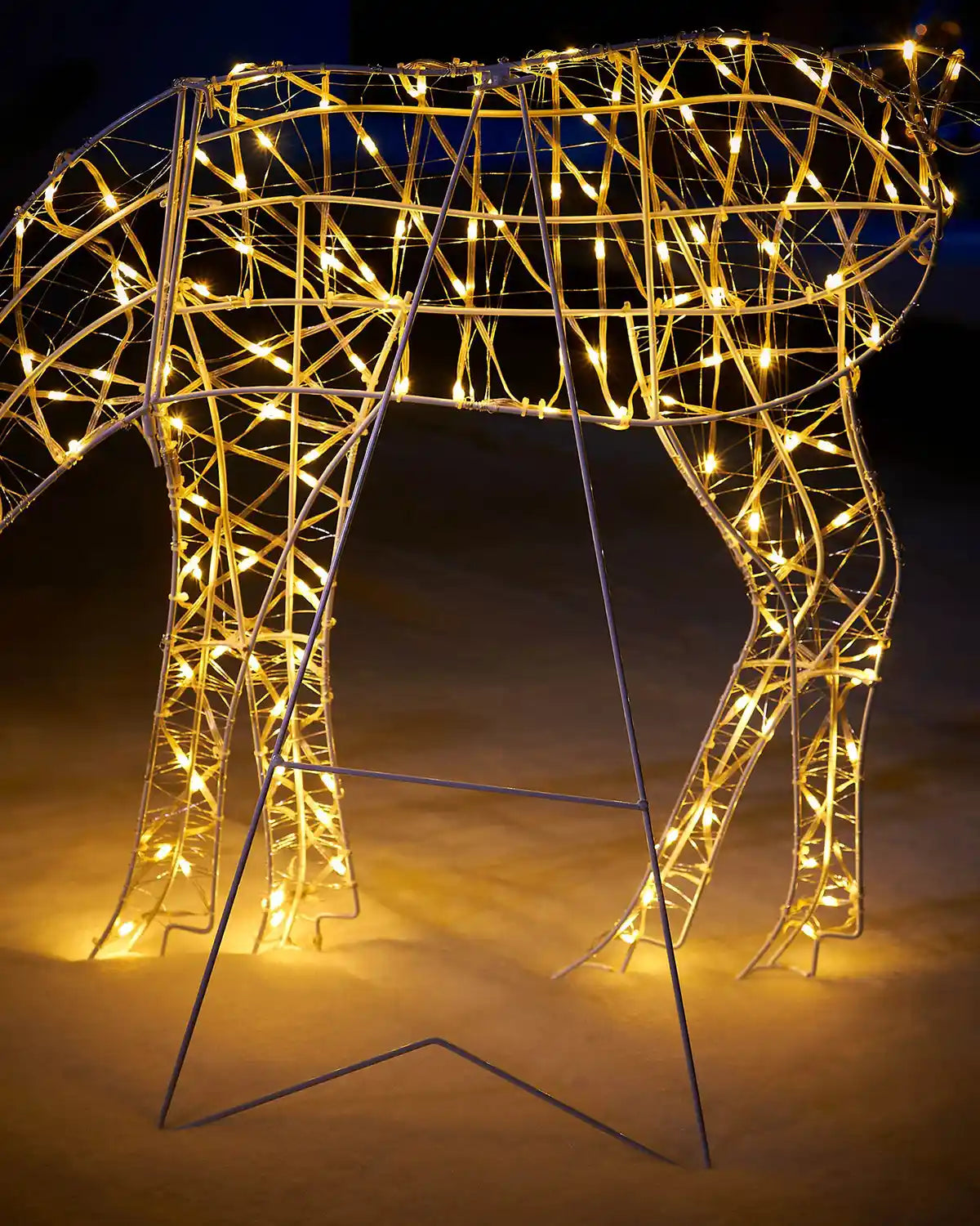 LED grazing reindeer with support stand in a snowy garden 