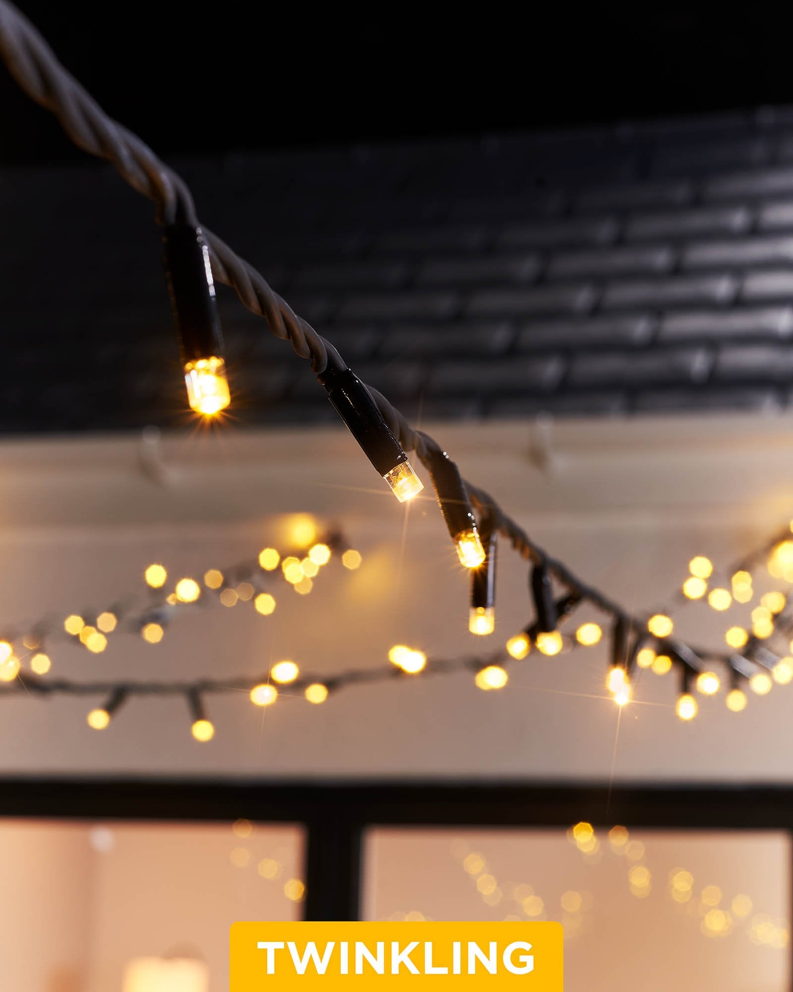 Close-up of warm white LED Christmas string lights with a focus on the twinkle or flashing feature, displayed against a blurred background of similar lights creating a cozy, festive atmosphere.