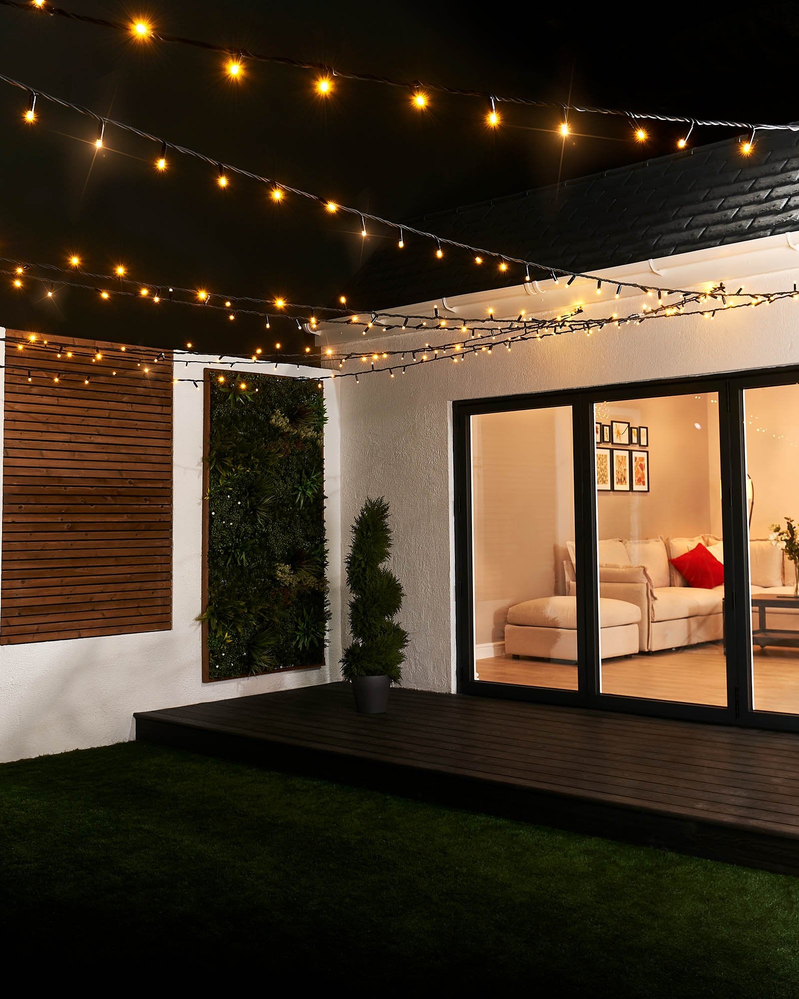 Close-up of warm white LED Christmas string lights with a focus on the twinkle or flashing feature, displayed against a blurred background of similar lights creating a cozy, festive atmosphere.