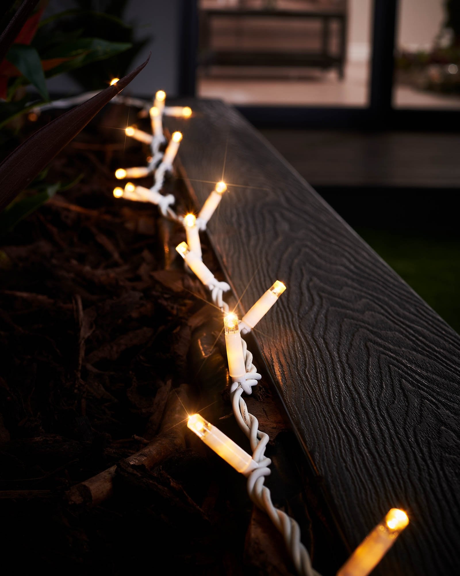 A close-up of connectable twinkle string lights with a focus on the LED bulbs, showcasing the twinkling feature.