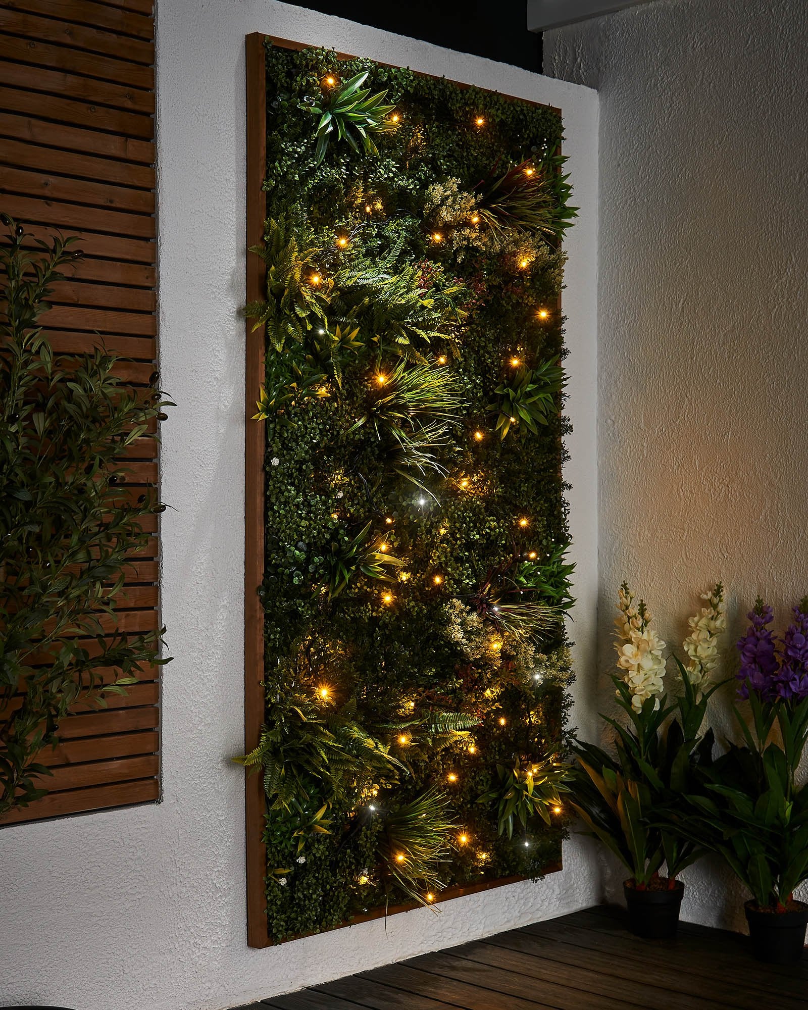 Close-up of connectable twinkle string lights with warm white and white LEDs, showcasing the twinkle effect. The image is taken during the evening with a blurred background.