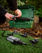 Large 15w Starter Transformer with 4 splitter connectors being attached green outdoor box