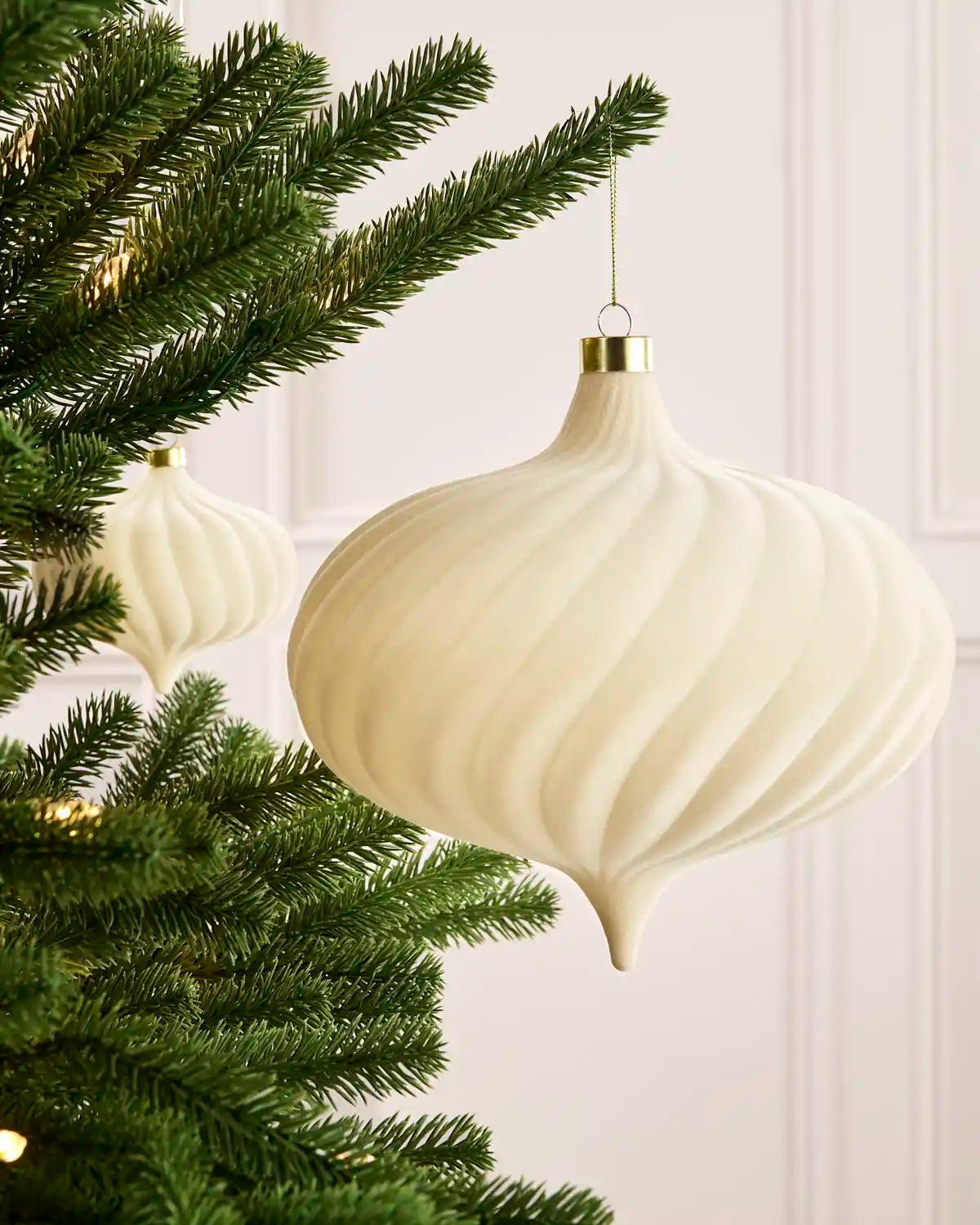 Latte 20 cm oversized velvet Spiral bauble displayed on a Christmas tree with coordinating ornaments.
