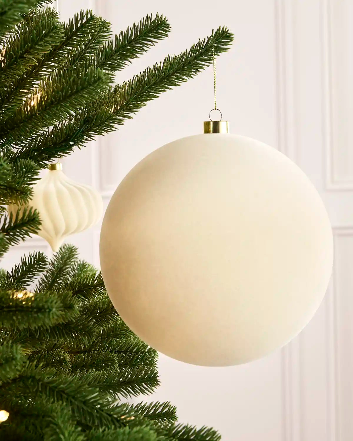 Latte 20 cm oversized velvet Traditional bauble displayed on a Christmas tree with coordinating ornaments.

