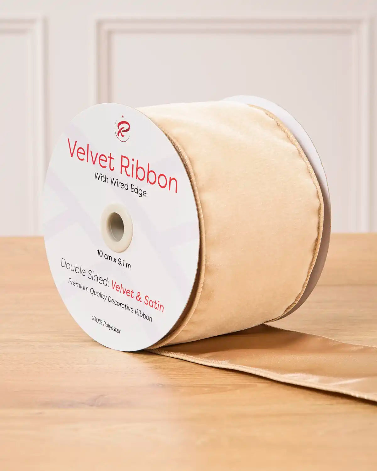 Latte Velvet Ribbon with wired edge on a wooden surface