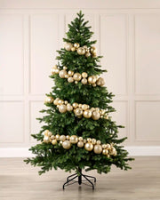 Latte bauble garland wrapped around a green Christmas tree with shiny, matt and glitter baubles.
